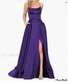 a woman in a long purple dress posing for the camera