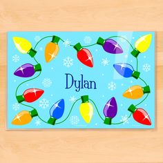 a placemat with christmas lights and the word dylan on it in blue