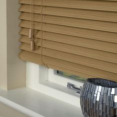 a window with blinds that are closed to let light in