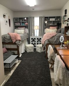 a bedroom with two beds and a rug on the floor