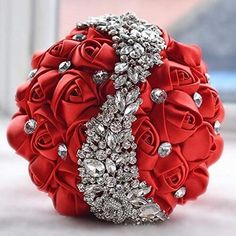 a bridal bouquet with red roses and crystals