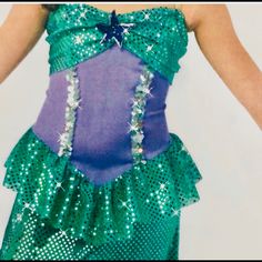 The Sparkly Mermaid Costume Comes With Adjustable Straps. Its Very Comfortable And Absolutely Lovely On And Off Stage. Please Note The Iridescent Sequins, The Ruffle At The Bottom Of The Skirt. This Costume Is Of Made Of Lycra/Spandex And The Ruffle At The Bottom Of The Skirt Makes For Ease Of Movement. Perfect For Play Or Stage Purple Mermaid Hem Dress With Ruffles, Purple Ruffle Mermaid Hem Dress, Purple Ruffled Dress With Mermaid Hem, Fitted Mermaid Hem Costume Dress, Purple Ruffled Mermaid Dress, Fitted Purple Mermaid Dress With Ruffles, Fitted Purple Mermaid Dress, Fitted Sleeveless Mermaid Dress For Dress-up, Purple Mermaid Dress For Dress-up