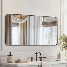 a bathroom sink with a large mirror above it