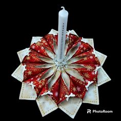 a red and white ornament with snowflakes on it