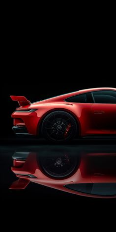 a red sports car is shown in the dark