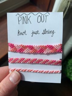 two pink and white bracelets are shown in front of a card that says, pink out not just string