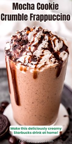 a close up of a drink on a plate with chocolate and marshmallows