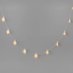 a string of star lights on a gray background