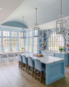 a blue and white kitchen with lots of windows