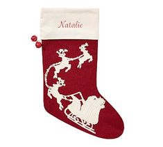 a red christmas stocking with santa riding a sleigh