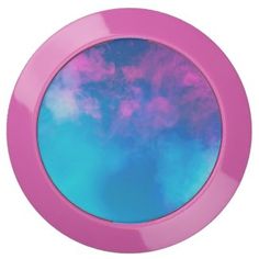 a pink and blue round mirror with clouds in it