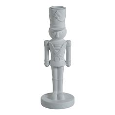 a white plastic toy soldier with a hat and tie on it's head, standing in front of a white background