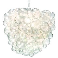 a chandelier made out of glass balls hanging from a metal chain on a white background