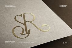 the letter r is made up of gold foil and has an elegant design on it