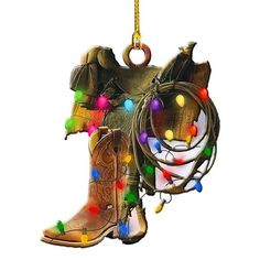 a cowboy boot ornament hanging from a rope with lights on the inside and around it