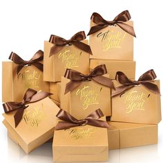 six brown boxes with thank you written on them, tied with satin ribbons and bows