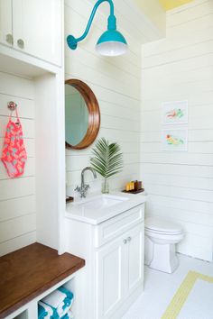 a bathroom with a sink, toilet and mirror