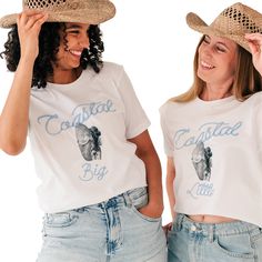 two women wearing cowboy hats and t - shirts with the words colgate big on them