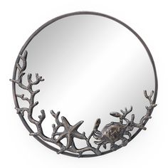 a round mirror with branches on it and a fish in the middle is hanging from the wall