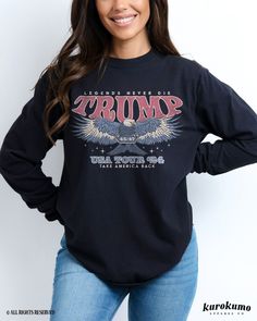 This Unisex garment-dyed long sleeve t-shirt features "Legends Never Die | TRUMP | USA Tour '24 | Take America Back" with a retro style illustration of an eagle soaring holding a sign that has "45/47" inscribed on it. It is the perfect tee for any patriot looking to show their support for President Trump this election year! Make sure to check out the other garment options below :) » O P T I O N S « ‣ Tshirt: https://www.etsy.com/listing/1748788180 ‣ Hoodie: https://www.etsy.com/listing/1771266895 ‣ Crewneck: https://www.etsy.com/listing/1748826622 ‣ Women's Boxy Tee: https://www.etsy.com/listing/1809795647 » A B O U T « ‣ This item is made to order using direct-to-garment (DTG) printing technology. This digital process involves the printer inks being jetted or sprayed onto the textile by a Fall Long Sleeve T-shirt With Front Print, Graphic Tee With Front Print Long Sleeve, Long Sleeve Graphic Tee With Front Print, Vintage Long Sleeve T-shirt With Text Print, Long Sleeve T-shirt With Front Print For Fall, Graphic Tee Shirt With Letter Print And Long Sleeves, Long Sleeve Graphic Tee Shirt With Letter Print, Long Sleeve Graphic Tee With Letter Print, Graphic Tee With Long Sleeves And Screen Print