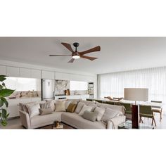 a living room filled with furniture and a ceiling fan