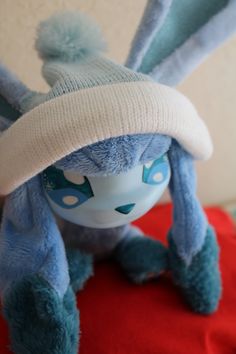 a blue stuffed animal wearing a white hat