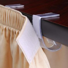 a close up of a curtain with a tie hanging from it's back end