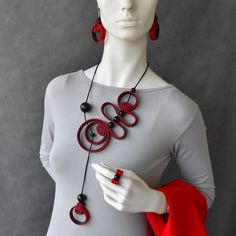 "Bohemian spiral black necklace with red accent, Statement bold necklace, Contemporary necklace, Unusual necklace. Bib necklace or set... Beautiful playful spiral necklace. Long, elegant, rich in shapes. Black necklace with red accent. Gorgeous stylish bohemian necklace. Eye catching artistic jewelry. Necklace is soft and light, very comfortable to wear. Dimensions: - Necklace length: 23\" / 59cm (around neck). - Earrings length: 2\"/ 5cm; Total drop length: 2.8\"/ 7cm. - Ring size by order Opti Black Party Jewelry With Unique Variations, Red Spiral Jewelry As Gift, Red Spiral Jewelry For Gifts, Spiral Shaped Red Jewelry For Gifts, Modern Red Necklace For Party, Adjustable Red Spiral Jewelry, Elegant Black Spiral Jewelry, Adjustable Black Spiral Necklace, Black Adjustable Spiral Necklace