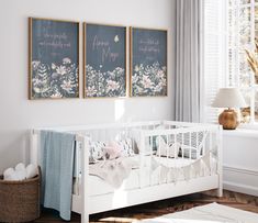 a baby's room with two paintings on the wall