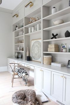 a large white bookcase with lots of books on it