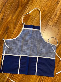 an apron is sitting on the floor next to a pair of scissors