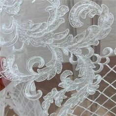 closeup of white lace on sheer fabric