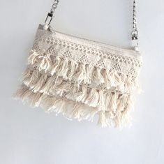 A cute crossbody bag with a Macrame fringe trim on one side is the perfect vacation purse!  This little bag gives off fun and flirty vibes all day long.  The natural color bag, paired with a sleek, silver crossbody chain (flat chain wears comfortably) this small bag goes from day to night with ease!    Details Mini size exterior dimensions are 7.5in L x 5in H Natural canvas exterior Cotton fringe trim on one side (back is canvas) 48 inch crossbody length Lined in a bold tropical print 7 inch zip Vacation Purse, Boho Market, Macrame Fringe, Cute Crossbody Bags, Fringe Crossbody Bag, Boho Fringe, Tassel Fringe, Boho Casual, Fringe Trim