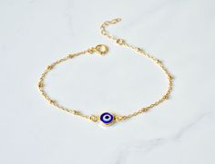 "Gold Filled Beaded Evil Eye Bracelet Handmade Turkish Glass and 18kt gold filled, every charm is made by hand so no one necklace is exactly the same. The charm on this necklace symbolizes good luck and safe keeping. Can be worn everyday and will not tarnish -Description Evil Eye Charm - Handmade Turkish Glass and 18kt gold filled, .5\" end to end Chain - 14kt Gold Filled Link or Beaded Chain Length- 5-8\" w/1\" extension See the last photo for bracelet measurement information The bracelets in t Spiritual Gold Beaded Bracelets With Charms, Adjustable Gold Evil Eye Bracelet With Charms, Handmade Gold Charm Bracelet With Round Beads, Yellow Gold Beaded Chain Bracelet As Gift, Gold Spiritual Evil Eye Bracelet With Adjustable Chain, Gold Evil Eye Bracelet With Charms As Gift, Gold Evil Eye Bracelet With Charms For Gift, Gold Charm Bracelet With Adjustable Chain And Round Beads, Gold Plated Beaded Bracelets As Gift