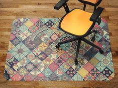 an office chair sitting on top of a colorful floor mat with a computer mouse pad