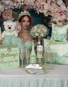 a woman sitting at a table in front of some bottles and glasses with teddy bears on them