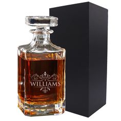 a bottle of whiskey sitting in front of a black box with the name william's on it