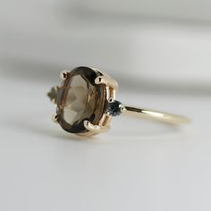 a close up of a ring with a stone on the top and two stones in the middle