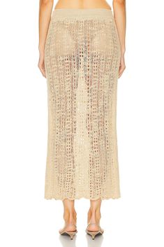 Find CULT GAIA Dawson Crochet Coverup Skirt In Tan on Editorialist. Cult Gaia Dawson Crochet Coverup Skirt in Tan 95% unshrinkable virgin wool 5% polyamide. Made in China. Hand wash. Unlined. Elastic waistband. Crochet knit fabric. Item not sold as a set. Garment is intentionally sheer, undergarments will show through. Please note undergarment not included. GAIA-WQ12. CCSRYN. About the designer: Cult Gaia first found popularity with its architecturally memorable Ark bag, carried by the influential fashion elite. Created in 2012, founder and designer Jasmin Larian took on the name Gaia from the goddess of Mother Earth and the daughter of chaos, along with the ideology that great brands are cult-like, uniting like-minded people in their aesthetic ideals. The label's design ethos is to create Fitted Knit Beach Skirt, Fitted Knit Skirt For Beach, Chic Knit Beach Skirt, Chic Beach Knit Skirt, Beach Fitted Maxi Skirt In Beige, Beach Fitted Beige Maxi Skirt, Beige Fitted Maxi Skirt For Beach, Beach Knit Beige Bottoms, Beige Knit Beach Bottoms