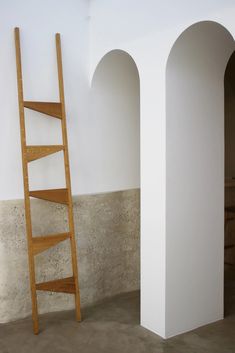 a wooden ladder leaning against a wall