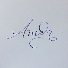 the word amr written in cursive ink on a piece of white paper