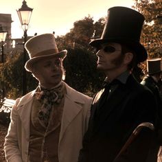 two men in top hats standing next to each other