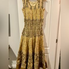 So Pretty Gold And Tan Sleeveless Dress. Sequin And Foil Finish In Hem. Paired With Matching Duppata And Pants. Worn Once Size Xl Waist: 37 In Length: 56 In Traditional Sleeveless Maxi Dress For Festive Occasions, Traditional Sleeveless Navratri Dresses, Traditional Sleeveless Festive Maxi Dress, Traditional Sleeveless Maxi Dress For Festivals, Traditional Sleeveless Cutdana Dress, Sleeveless Cutdana Salwar Kameez For Festivals, Elegant Sleeveless Dress For Diwali, Sleeveless Anarkali Salwar Kameez With Chikankari Embroidery, Sleeveless Anarkali Set For Eid Party