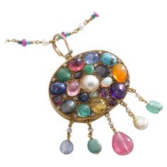 Multi Gems cabochon, Mother of Pearl and small diamond on Gold Pendant chain Necklace. Emerald, Sapphire, Ruby, Turquoise Matrix, Amethyst, Pearl, Opal, Citrine, Peridot, Garnet, Diamond. Mid 20th Century. Size of the pendant: Total height: 2.95 inches (7.50 centimeters) including bail. Total width: 1.77 inch (4.50 centimeters). Chain length: 24.80 inches (63.00 centimeters). Total weight pendant and chain: 38.64 grams. Former property of a French Lady. Yellow Gold Multi-stone Cabochons For Fine Jewelry, Yellow Gold Multi-stone Cabochons Fine Jewelry, Luxury Multi-stone Oval Cabochons, Elegant Multicolor Cabochon Gemstones, Fine Jewelry Multicolor Cabochon Gemstones, Multicolor Cabochon Gemstones Fine Jewelry, Multicolor Cabochon Gemstones For Fine Jewelry, Exquisite Oval Jewel Necklaces, Yellow Gold Multi-stone Cabochons For Gift