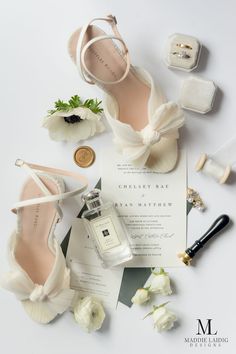 the wedding shoes and groom's accessories are laid out