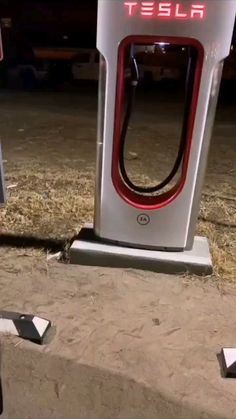 the tesla charging station is empty on the side of the road, and it's broken down