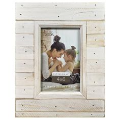 a white wooden frame with an image of a mother and her two children in it