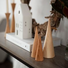 three wooden trees sitting on top of a table