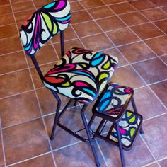 two colorful chairs sitting on top of a tiled floor