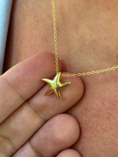 Our dainty starfish necklace is perfect for this summer! Information: ⭐️ Sterling Silver (925 stamped) | 14K Gold Plated ⭐️ Adjustable length: 16" - 18" ⭐️ Starfish charm size: about that of a dime ⭐️ Hypoallergenic ⭐️ Tarnish resistant This summer, starfishes and ocean inspired jewelry are your go-to jewelry staples. Our starfish necklace is dainty and looks amazing when layered. If you are going for a minimalist look, you can wear it by itself. Throughout centuries, starfishes have been seen a Dainty Gold Starfish Necklace, Gold Starfish Charm Necklace Gift, Yellow Gold Starfish Charm Necklace For Beach, Yellow Gold Star Necklaces With Starfish Charm, Yellow Gold Necklace With Starfish Charm For Beach, Yellow Gold Starfish Necklace As Gift, Dainty Star-shaped Necklace With Starfish Charm, Dainty Starfish Necklace For Gift, Dainty Starfish Necklace As Gift